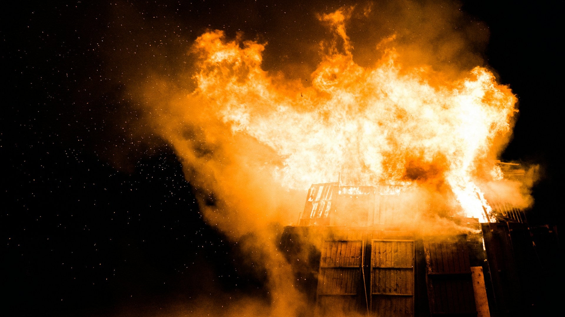 A dramatic house fire at night — the moment SafeGuard protects what matters most